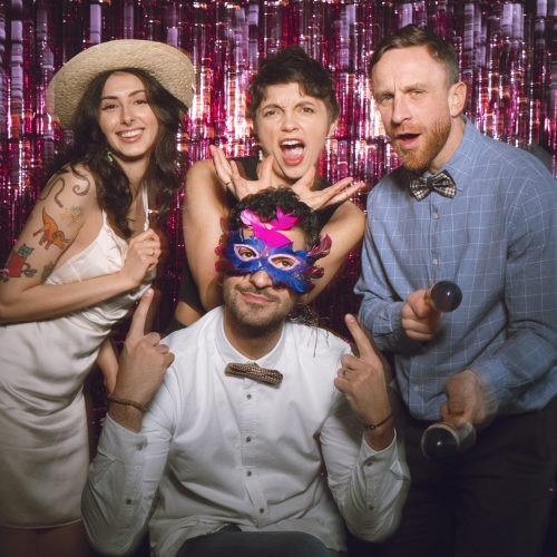 medium-shot-friends-posing-together-photobooth